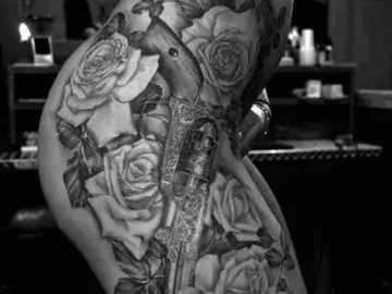 Guns and roses thigh tattoo